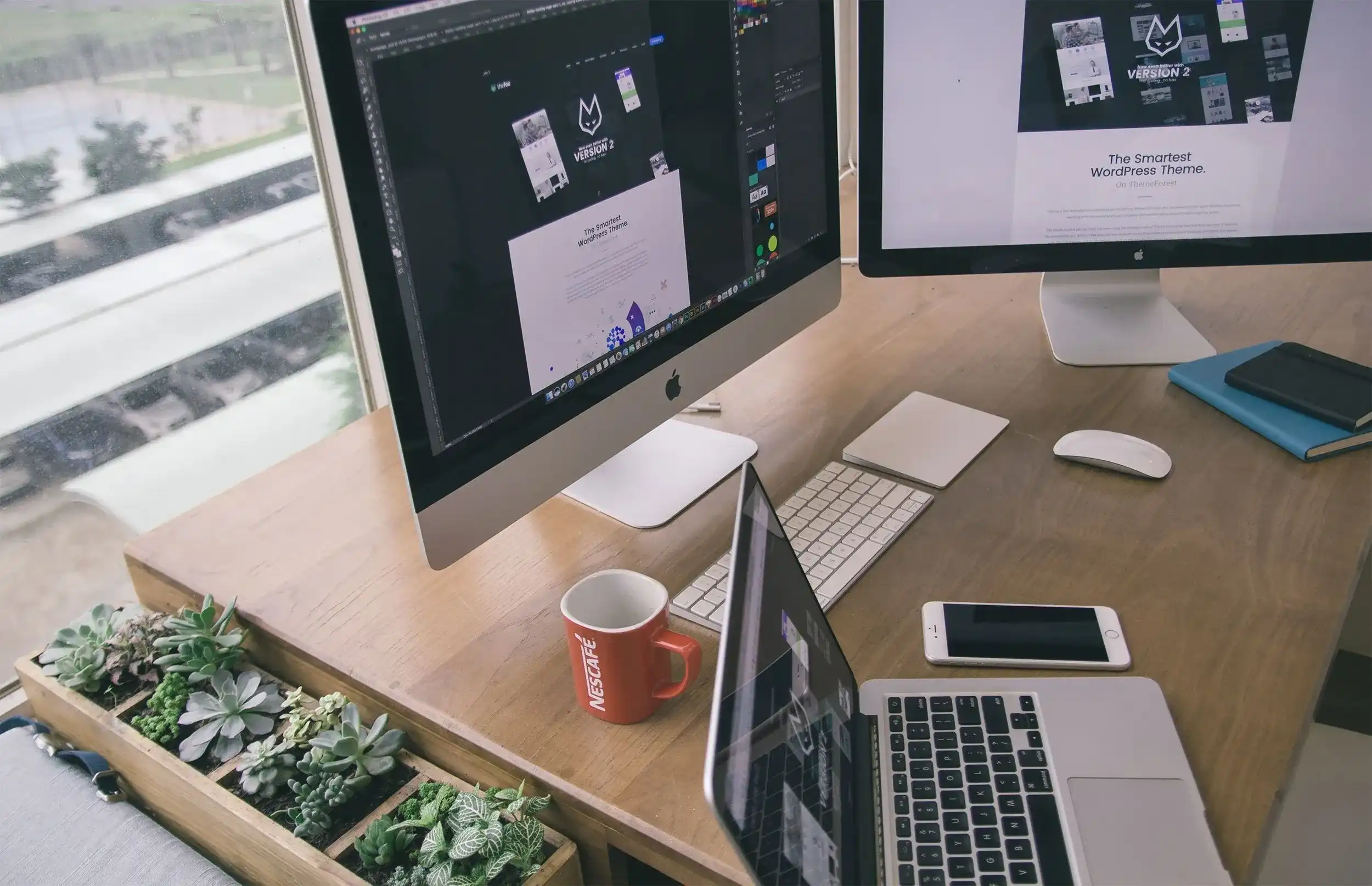 Computer and laptop on desk